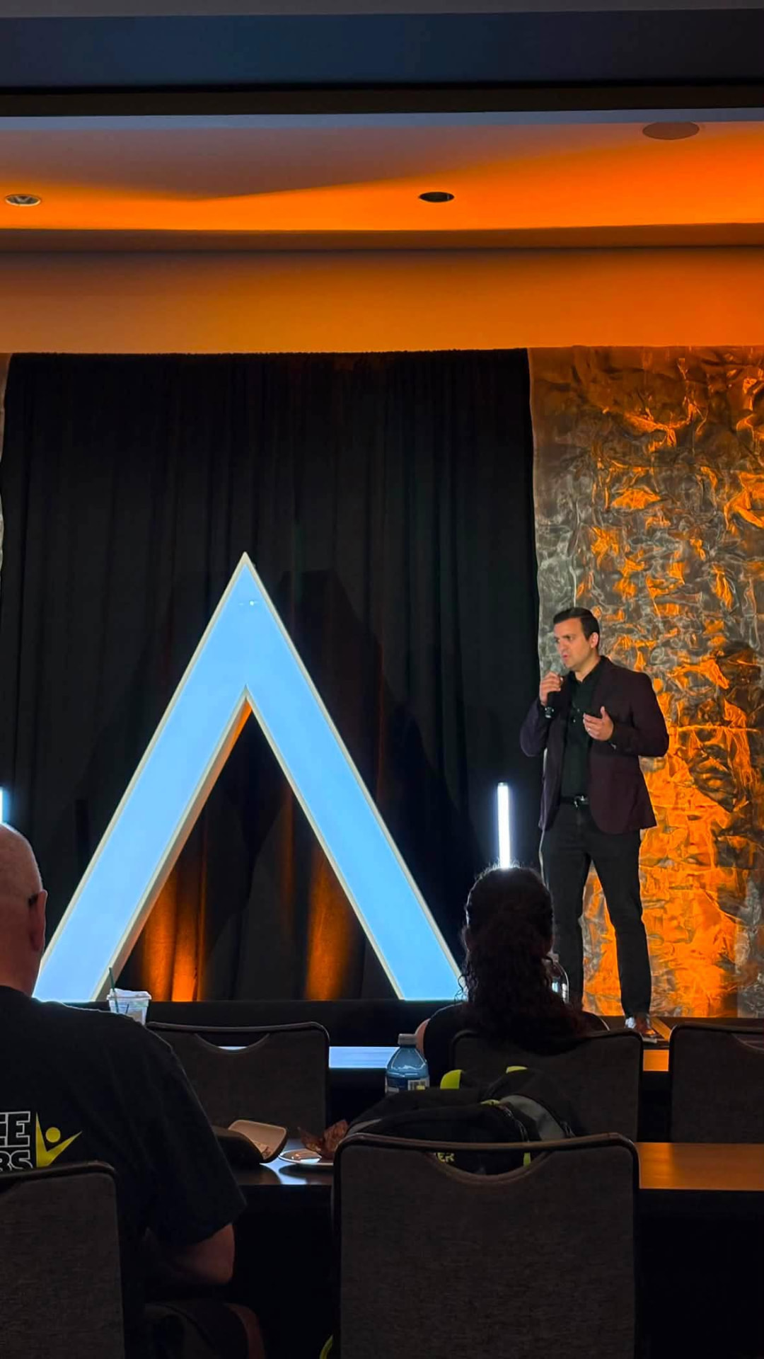 Speaking on stage at an industry summit